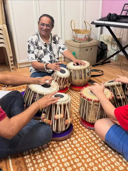The rhythm of India is taught in our tabla classes. Here, students of different generations learn the intricate 'bols' and techniques of this classical percussion instrument together in a group setting.