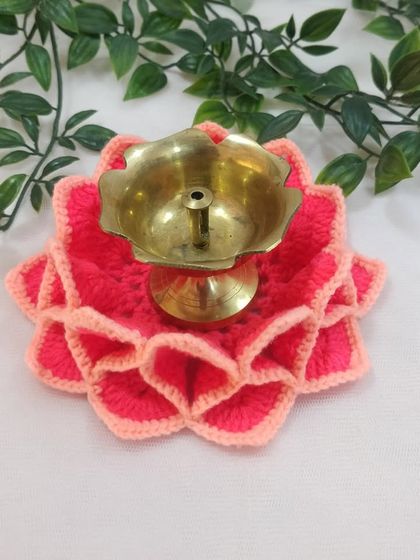 This two-toned pink lotus aasan serves as a beautiful base for a traditional brass samai, or oil lamp.