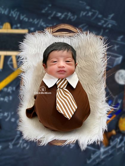 The littlest scholar. Dressed in a tiny collar and tie, this baby is ready for a bright future, set against a charming chalkboard backdrop with formulas and globes.