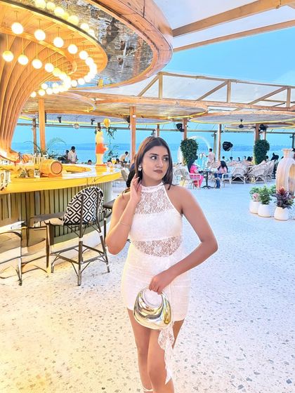 A full-length shot of the white lace dress and my metallic bag.