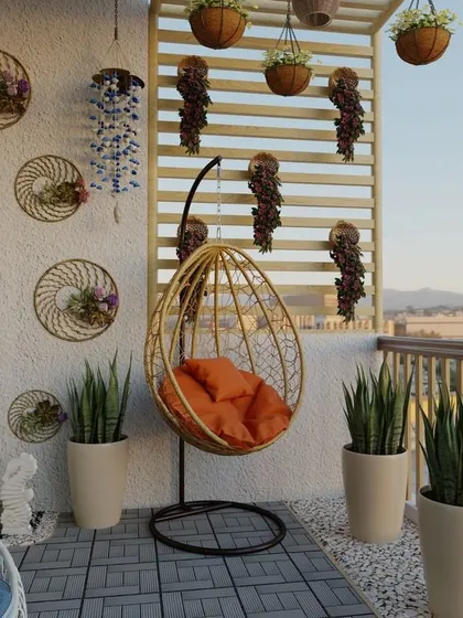 A bright and cheerful balcony with a golden swing chair and elegant wall decor. We used tall snake plants in simple white pots to add vertical interest and a touch of green.