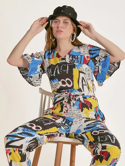 A playful pose with the model adjusting her hat, adding a story and personality to the fashion shot.