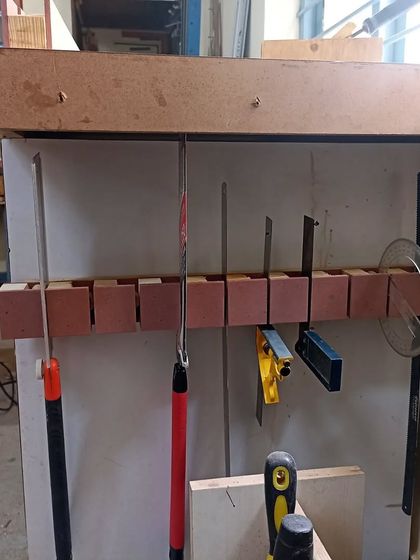 The saw till in use, holding a variety of saws, squares, and a protractor. Everything has its place.