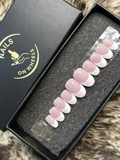 Another view of my classic oval-shaped French manicure set. This shows the consistent curve and finish across all the nails, which are sized to fit your natural nail bed perfectly.