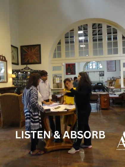 Listening and absorbing are key skills in architecture. This image shows a team discussion within a library, emphasizing the importance of collaborative learning and absorbing knowledge from peers and mentors.