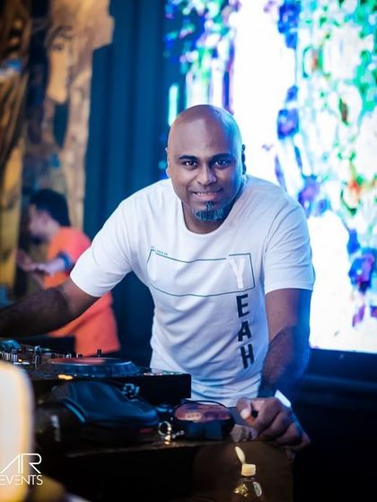 A smiling shot of me at the Pioneer DJ decks. I genuinely love what I do, and it shows in the energy I bring to every set.