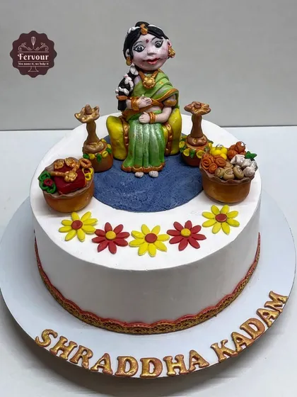 A traditional Godh Bharai (baby shower) cake. This chocolate truffle cake features a detailed, hand-crafted fondant figure of a mother-to-be in traditional attire.