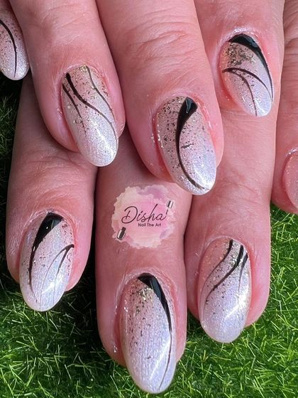 A sophisticated design with a pearlescent base, black swirls, and a sprinkle of glitter.