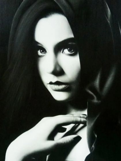 A dramatic black and white portrait created by a student, demonstrating mastery of light and shadow to create a moody, intense atmosphere.