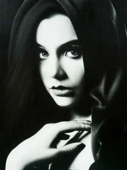 A dramatic black and white portrait created by a student, demonstrating mastery of light and shadow to create a moody, intense atmosphere.