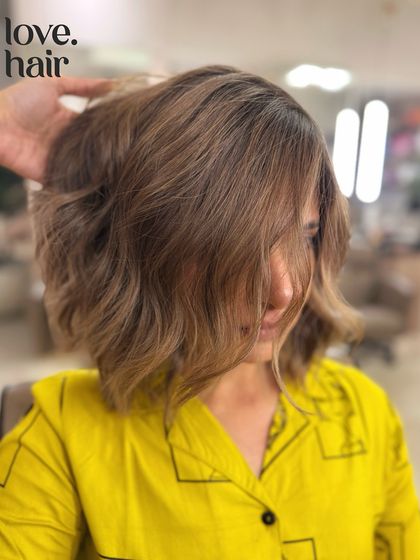 A side profile of the ash blonde bob, showing how the colour and cut work together to create a chic and modern silhouette.