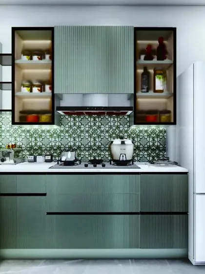 The design seamlessly incorporates large appliances like this double-door refrigerator. The glass cabinets with internal lighting are perfect for displaying glassware.