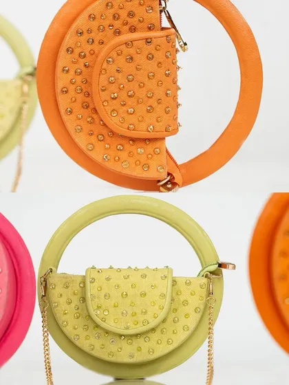 These aren't macaroons, they're my semi-circle mini bags. This shot shows the unique design in three vibrant colours: orange, lime green, and fuchsia, each studded with tiny crystals.