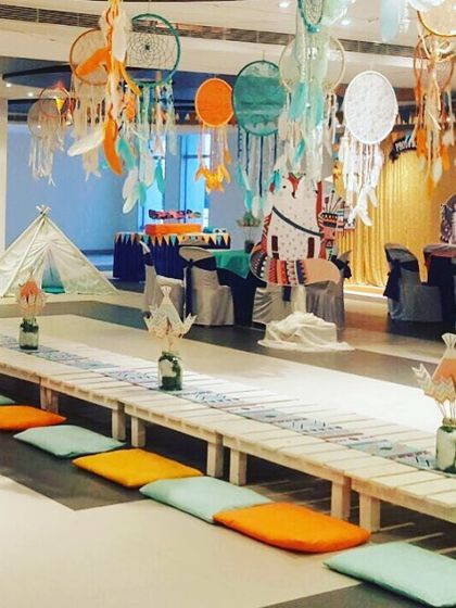 Low seating arrangement for a tribal "pow-wow" party. I used floor cushions and long wooden benches to create a communal and relaxed atmosphere for the kids.