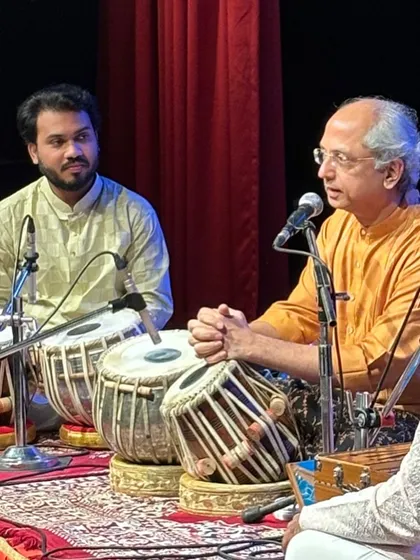 Listening intently as my Guruji speaks during a concert. Sharing the stage with him is the highest honor and a profound learning experience.
