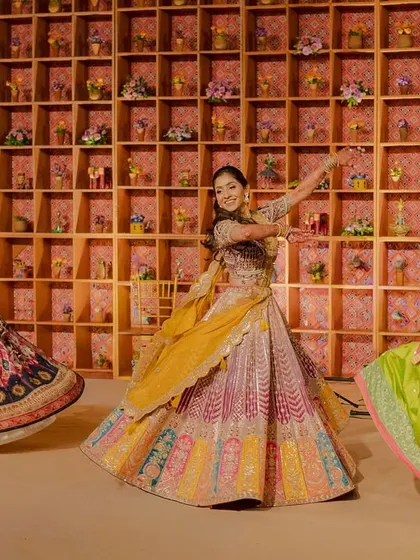 A dynamic shot of the bride and her friends dancing at the Garba. The colorful lehengas and joyful energy are the heart of this celebration.