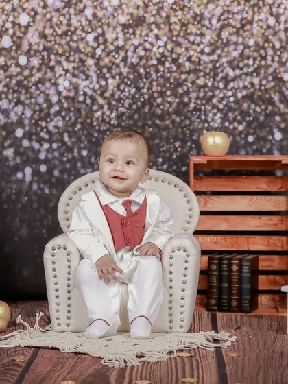 A happy smile from the star of our glitter-themed shoot. The warm lighting and festive background make these photos perfect for any special occasion.