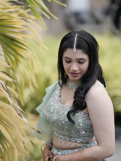 A beautiful shot framed by nature, her soft makeup glowing.