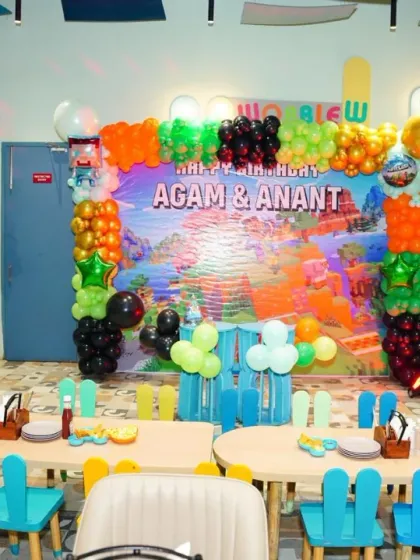 A Minecraft-themed birthday setup for Agam and Anant. The pixelated backdrop and character props bring the popular game to life.