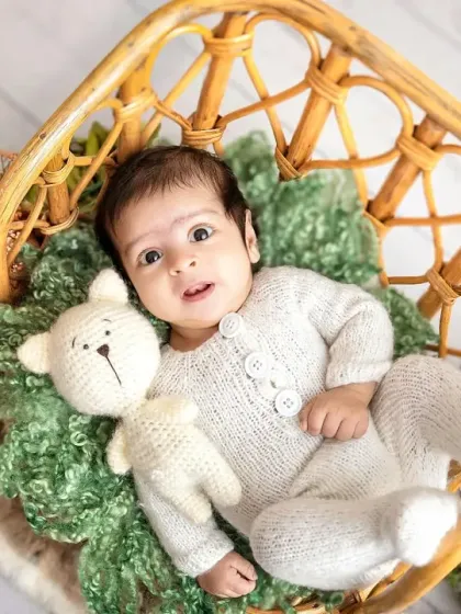 An adorable awake moment in the rattan chair. His wide-eyed look and little hand reaching out make this such an engaging and sweet portrait.