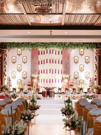 An intimate engagement ceremony where traditional motifs meet contemporary design. We created a stunning backdrop with floral strings and classic 'gopuram' niches, ensuring the setting was as special as the occasion itself.