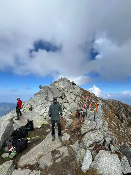 Another shot from the summit of Minkiani Pass, showing the rugged, rocky terrain at the top.