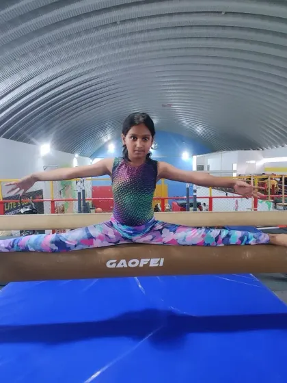 Another one of our talented gymnasts mastering the beam split. We train our students to perform these skills with grace and precision.