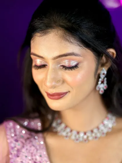 A close-up of a glamorous reception look. The focus is on the sparkling silver eyeshadow and the flawless, glowing skin.