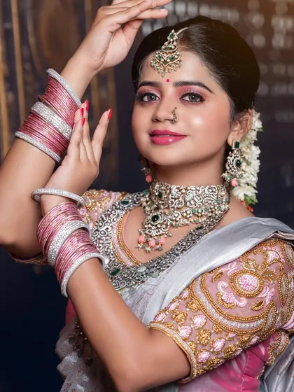 A close-up of the silver saree look, showing the delicate makeup and jewellery.