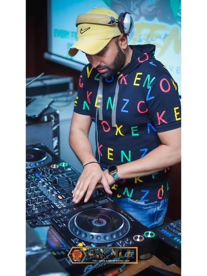 It's all about the vibe. Here I am at the console, focused on the music and getting ready to drop the next banger for the crowd.