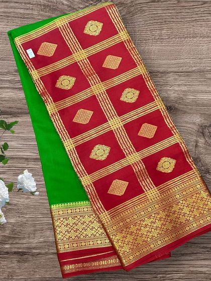 A festive half-and-half pure Mysore crepe silk saree with a parrot green body and a vibrant red pallu.