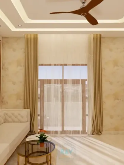 This living room is bathed in natural light, with a comfortable sofa and a clean, minimalist design. The false ceiling with cove lighting adds a layer of sophistication to the space.