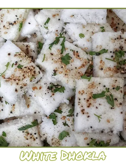 Super soft White Dhokla, also known as Khatta Dhokla, is a tangy and savory steamed snack made from fermented rice and lentil batter.