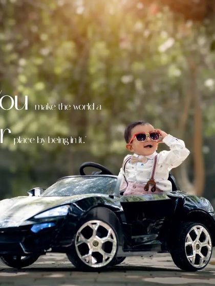 You make the world a better place by being in it. A cool toddler with sunglasses enjoys the ride in his toy car.
