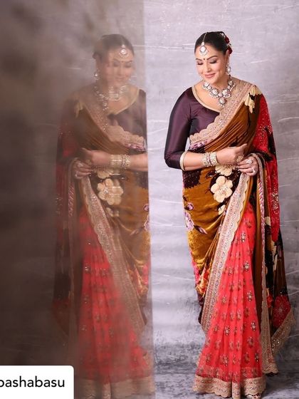 A full-length shot of Bipasha, capturing the elegance of her outfit against a reflection. We use creative compositions to add an artistic touch to our event photography.