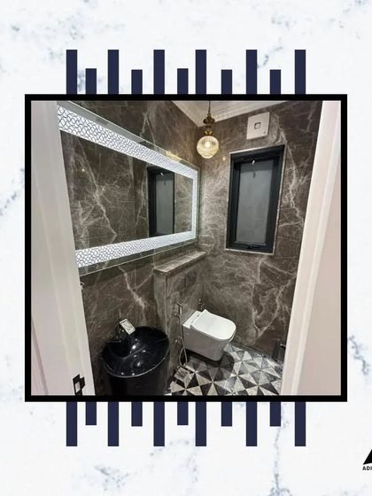 This bathroom features a unique black sink that contrasts beautifully with the dark marble walls. The geometric floor pattern adds another layer of visual interest.
