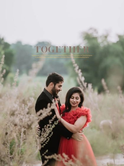 A soft, dreamy portrait of the couple in a field of wildflowers. The focus is on their gentle interaction, creating a timeless and romantic image.