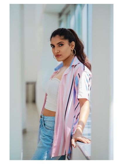 A casual and confident outdoor portrait. The natural lighting and relaxed pose create an authentic and relatable image.