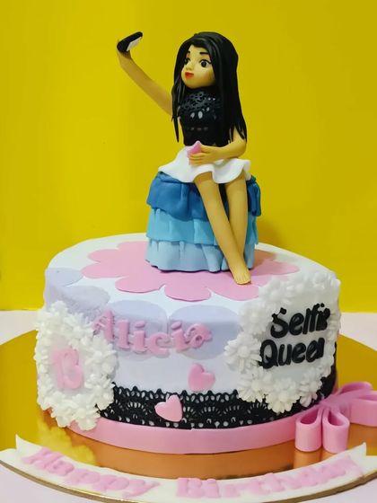 A cake for the "Selfie Queen." This design features a custom fondant figurine taking a selfie, perfect for a modern, social media-savvy birthday girl.
