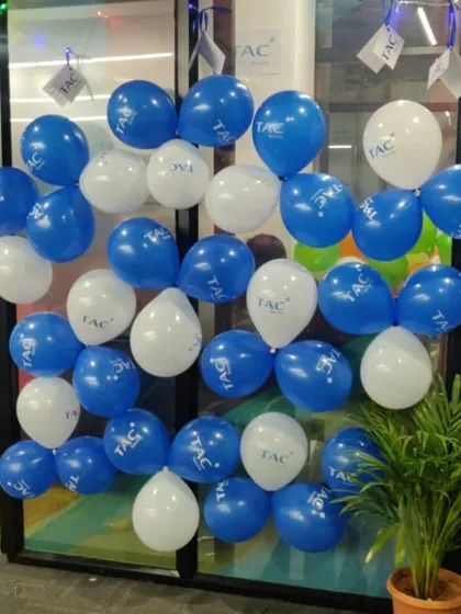 We help businesses integrate their branding directly into their event decor. Here, we used custom-printed balloons featuring the TAC Security logo for a clean, professional, and festive look within their office space.