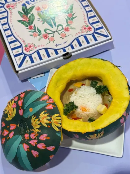 Thai green curry served in a hand-painted pumpkin, created for the Ajio Luxe café. This dish is a perfect example of how we combine bold flavors with unique, artistic presentation.