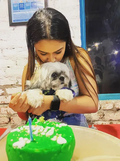 It's moments like these that we live for. A simple kiss, a happy dog, and a special birthday cake to mark the day. This is the pure, simple love that inspires every cake we bake.