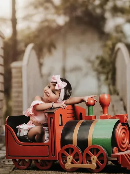 Leaning back and enjoying the ride. This little girl's relaxed and happy pose on the toy train is absolutely adorable.