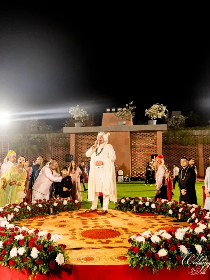 The groom's arrival at the venue, greeted by a stunning floral arrangement, marking the start of the wedding ceremony.