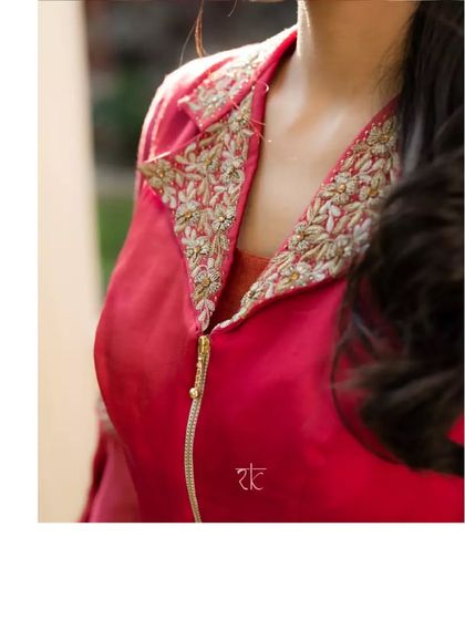 A close-up of the exquisite hand-embroidery on the jacket's collar, showcasing delicate zardosi work in a leaf pattern.