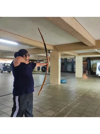 A student takes aim during an indoor session. The controlled environment is perfect for focusing on technical details.