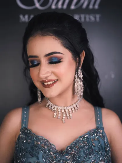 A close-up of the engagement bride's stunning makeup. The bold blue smokey eye is the star of the show, balanced by a flawless base and a soft lip color.
