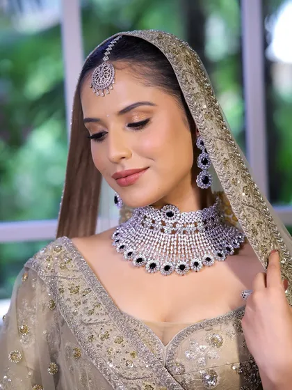 Timeless ivory elegance. This look features a soft base and bronze eyes, perfect for brides who want a traditional yet sophisticated makeover.