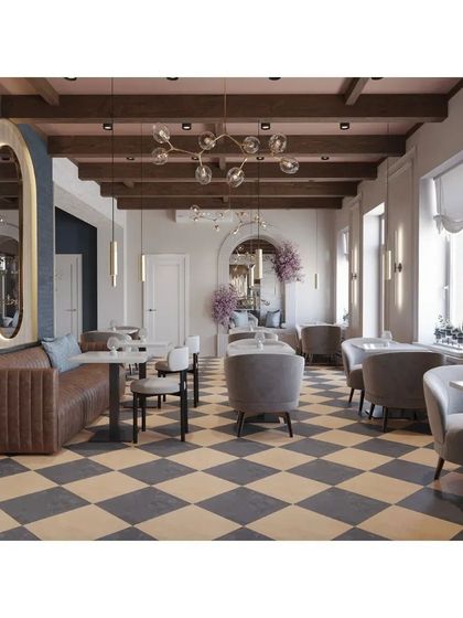 An overall view of the cafe, showing the spacious layout and classic design elements. The hanging floral arrangement adds a touch of softness and romance to the interior.