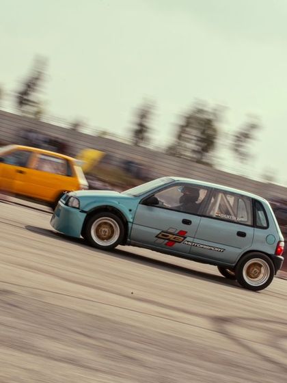 Another shot of the two hatchbacks battling it out, showcasing the excitement of grassroots drag racing.